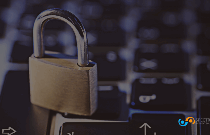 Closed padlock resting on a computer keyboard, symbolizing secure online payment processing and data protection by Spectrum Payment Solutions