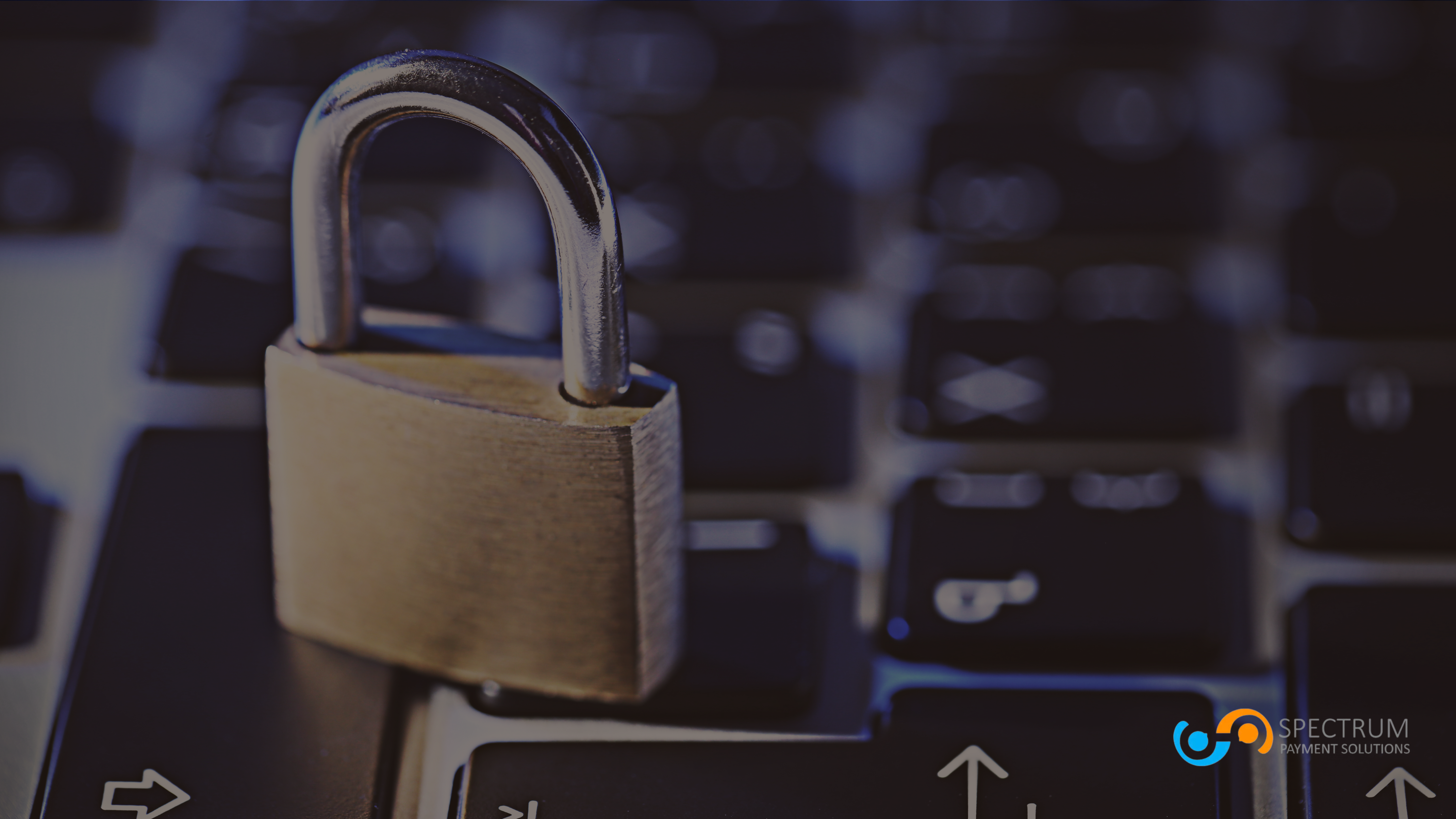 Closed padlock resting on a computer keyboard, symbolizing secure online payment processing and data protection by Spectrum Payment Solutions