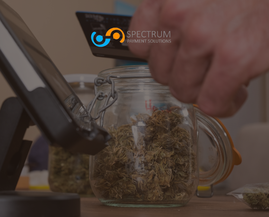 A person paying with a credit card at a cannabis dispensary