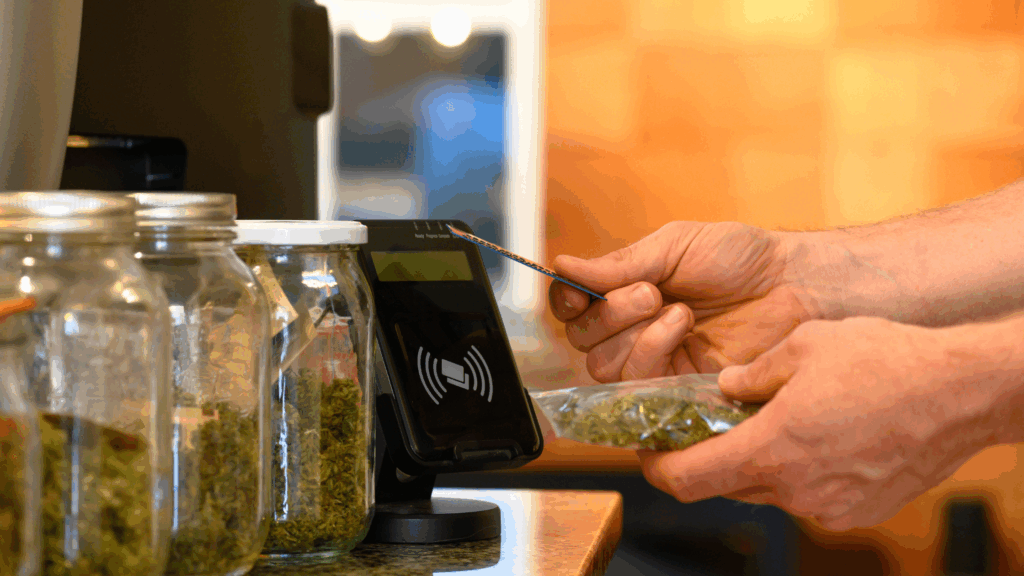 A person paying at a cannabis dispensary